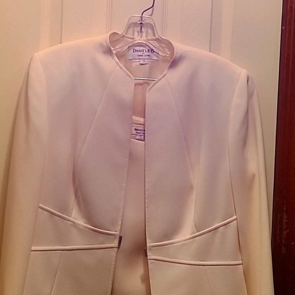 Three pieces jacket, shell with skirt. Color is Ivory. Size 12